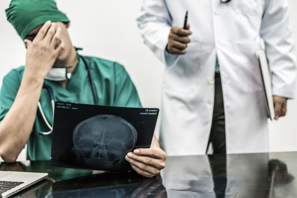 sad doctor holding an xray