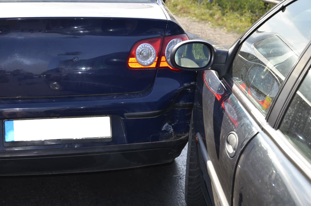 Sideswipe car crash on road