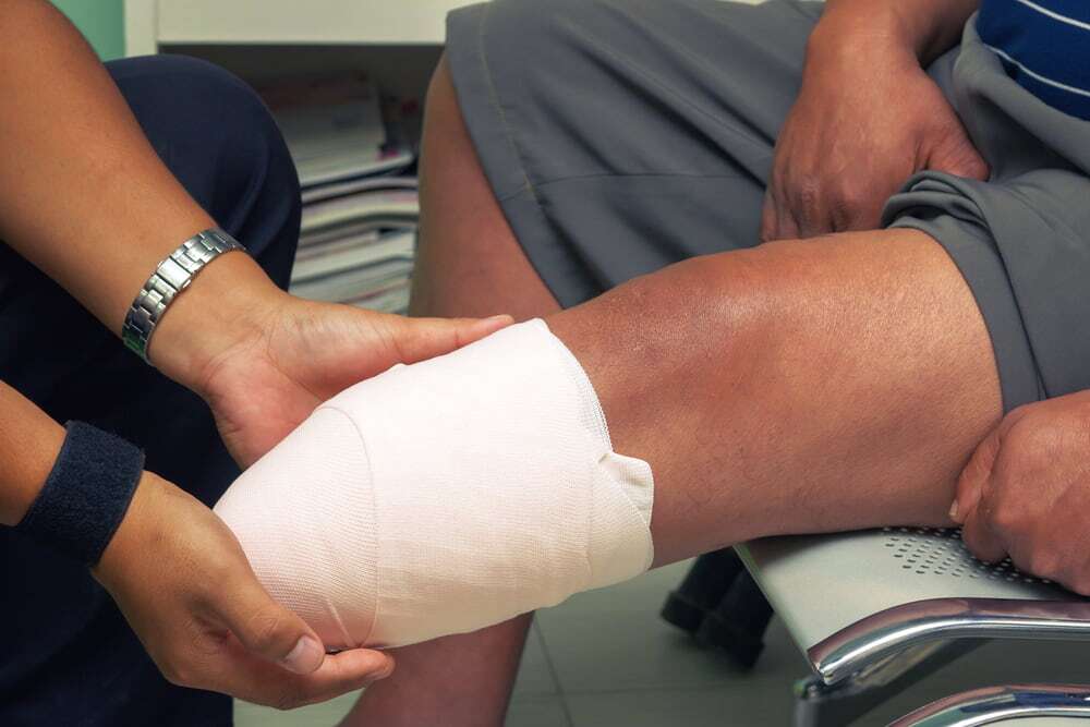 Doctor checks the limb of a patient after amputation