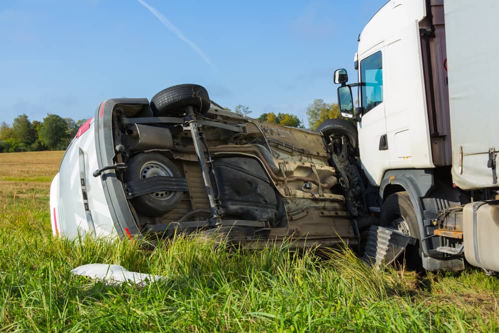Car overturned after crashing into a truck