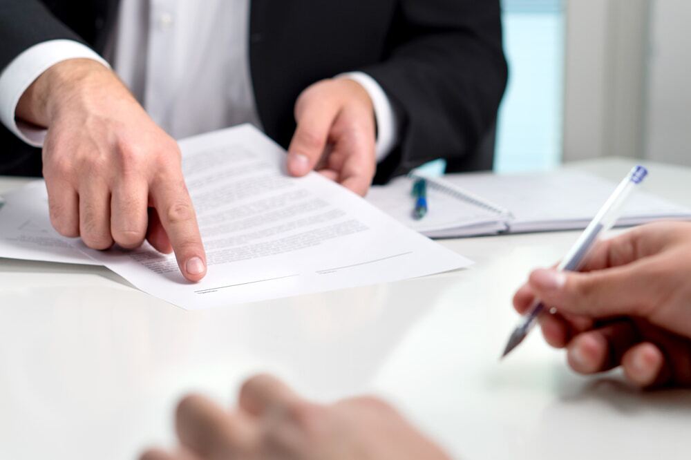 Lawyer and client signing papers