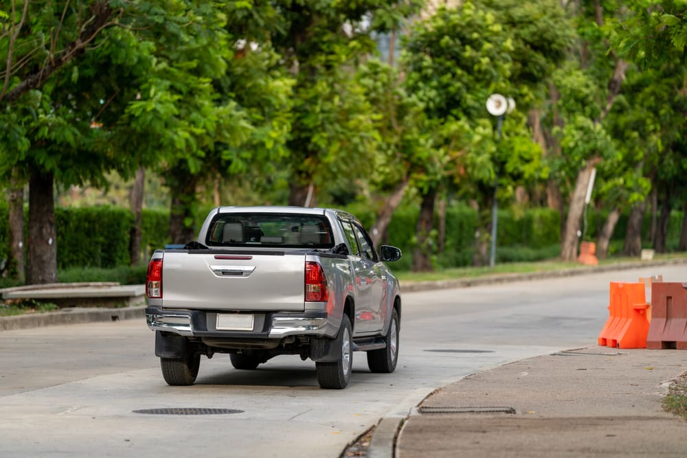 Pick up truck crossing down the street