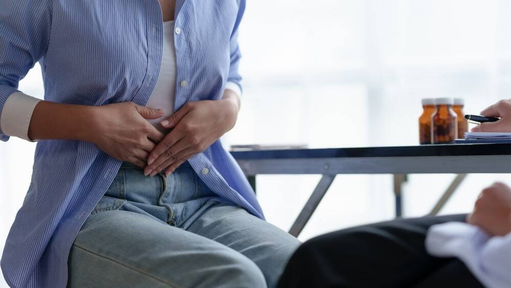 Woman complaining of abdominal pain after an accident