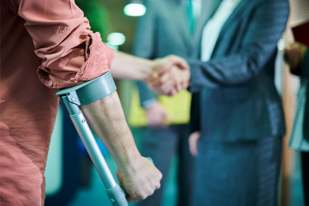 Injured man shakes his lawyer's hand