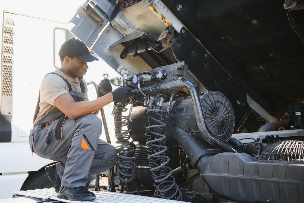 Mechanic checking a truck engine