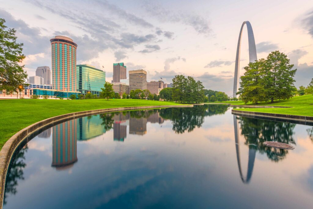 St. Louis skyline and Gateway Arch reflecting in water served by St. Louis car accident lawyers.