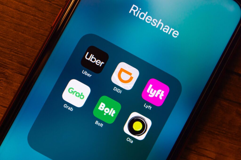 A smartphone screen displaying popular rideshare applications relevant to St Louis Uber and Lyft accident lawyers.